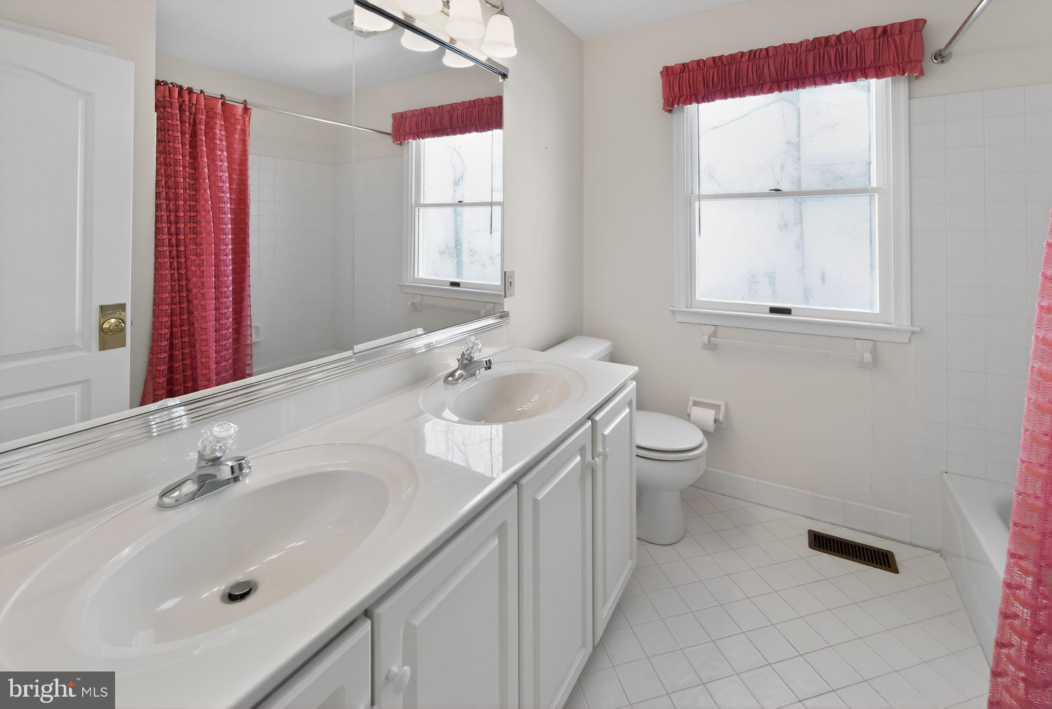 221 Cullen Way Newark, DE 19711 - Photo 27 of 37 a bathroom with a toilet sink and mirror