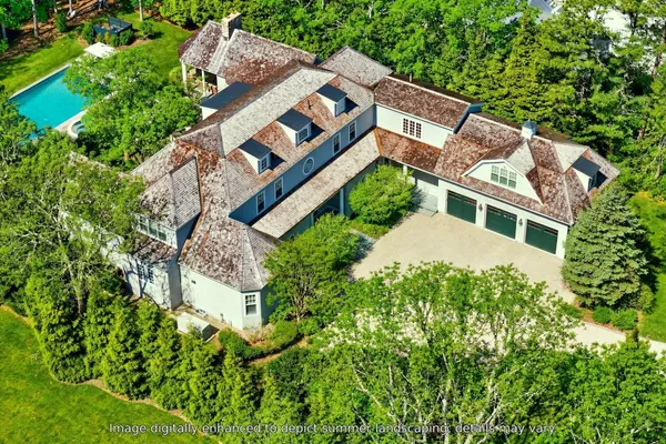 an aerial view of a house with a yard