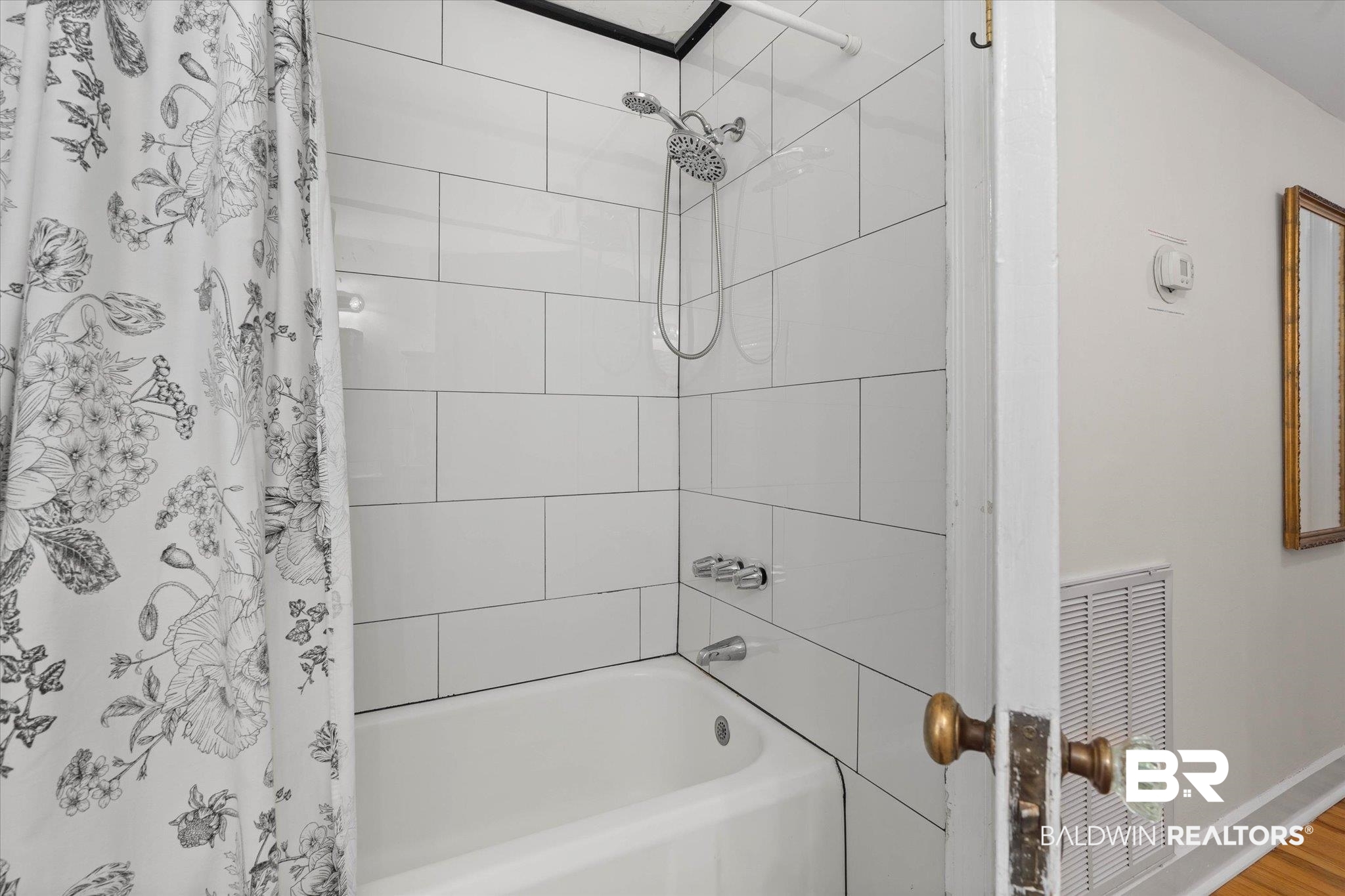 214 Upham Street, Unit 18A Mobile, AL 36607 - Photo 19 of 29 Full bath featuring shower / tub combo and wood finished floors