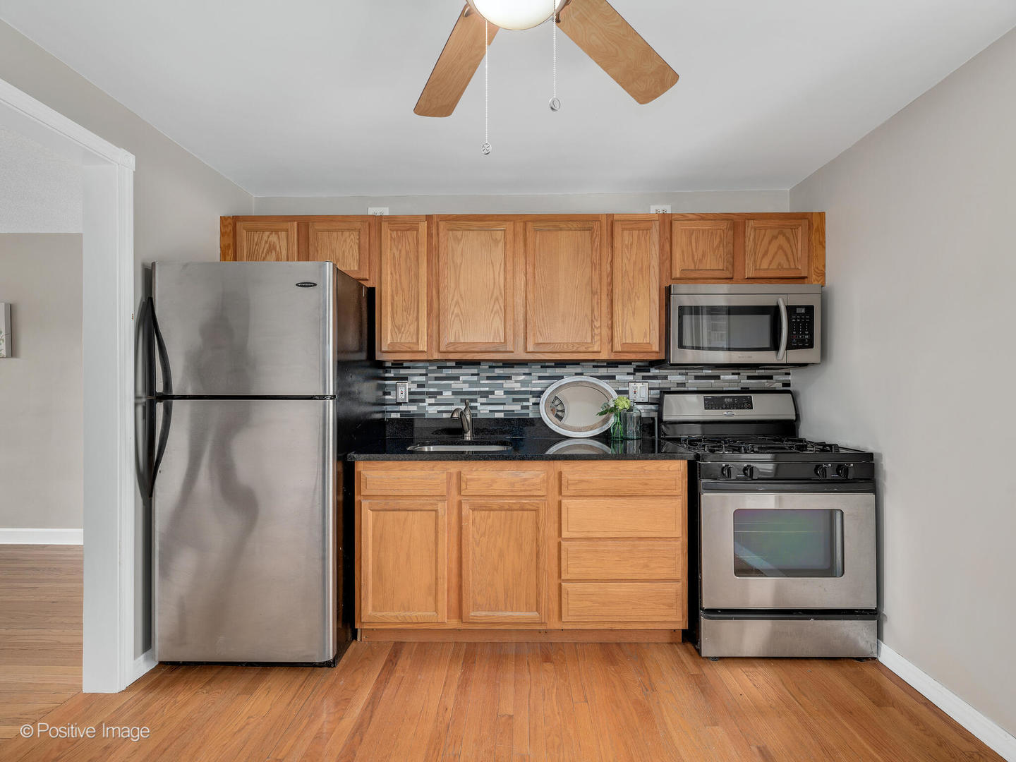 3505 Prairie Avenue, Unit 2W Brookfield, IL 60513 - Photo 7 of 11 a kitchen with stainless steel appliances granite countertop a refrigerator and a stove top oven