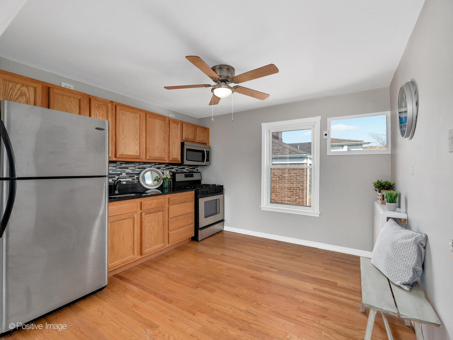 3505 Prairie Avenue, Unit 2W Brookfield, IL 60513 - Photo 8 of 11 a kitchen with stainless steel appliances granite countertop a refrigerator sink and white cabinets