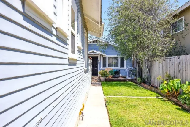a view of a house with a swimming pool and sitting area