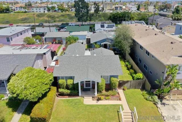 an aerial view of a house with a garden and lots of trees