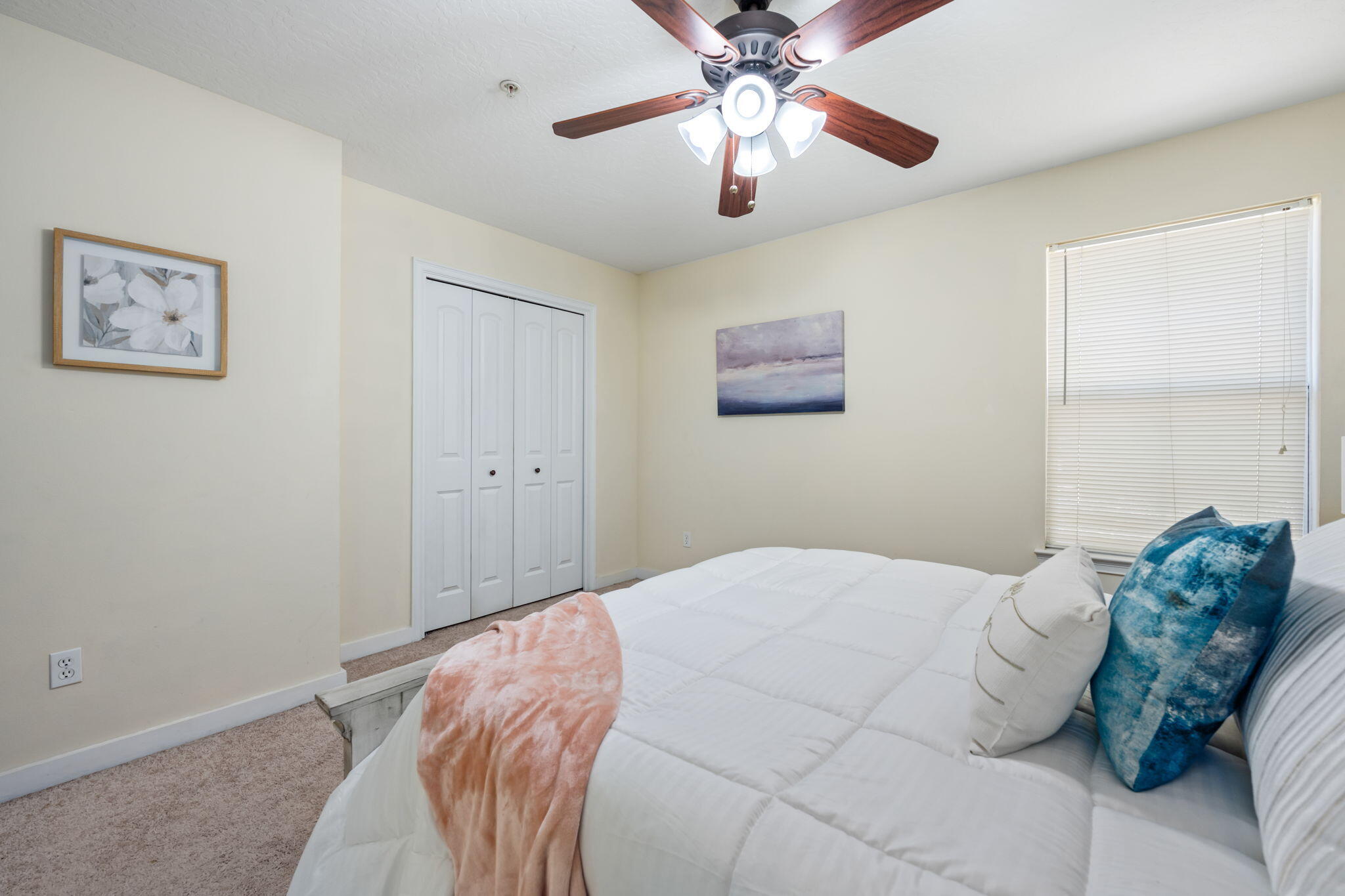 108 Hawkins Road, Unit E Fort Walton Beach, FL 32547 - Photo 19 of 41 a bedroom with a large bed and a chandelier