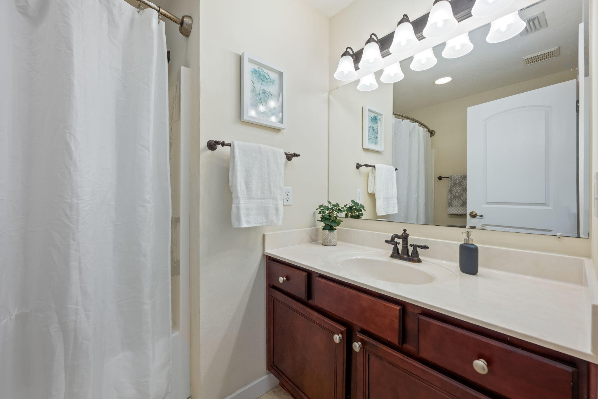 108 Hawkins Road, Unit E Fort Walton Beach, FL 32547 - Photo 20 of 41 a bathroom with a sink vanity and a mirror