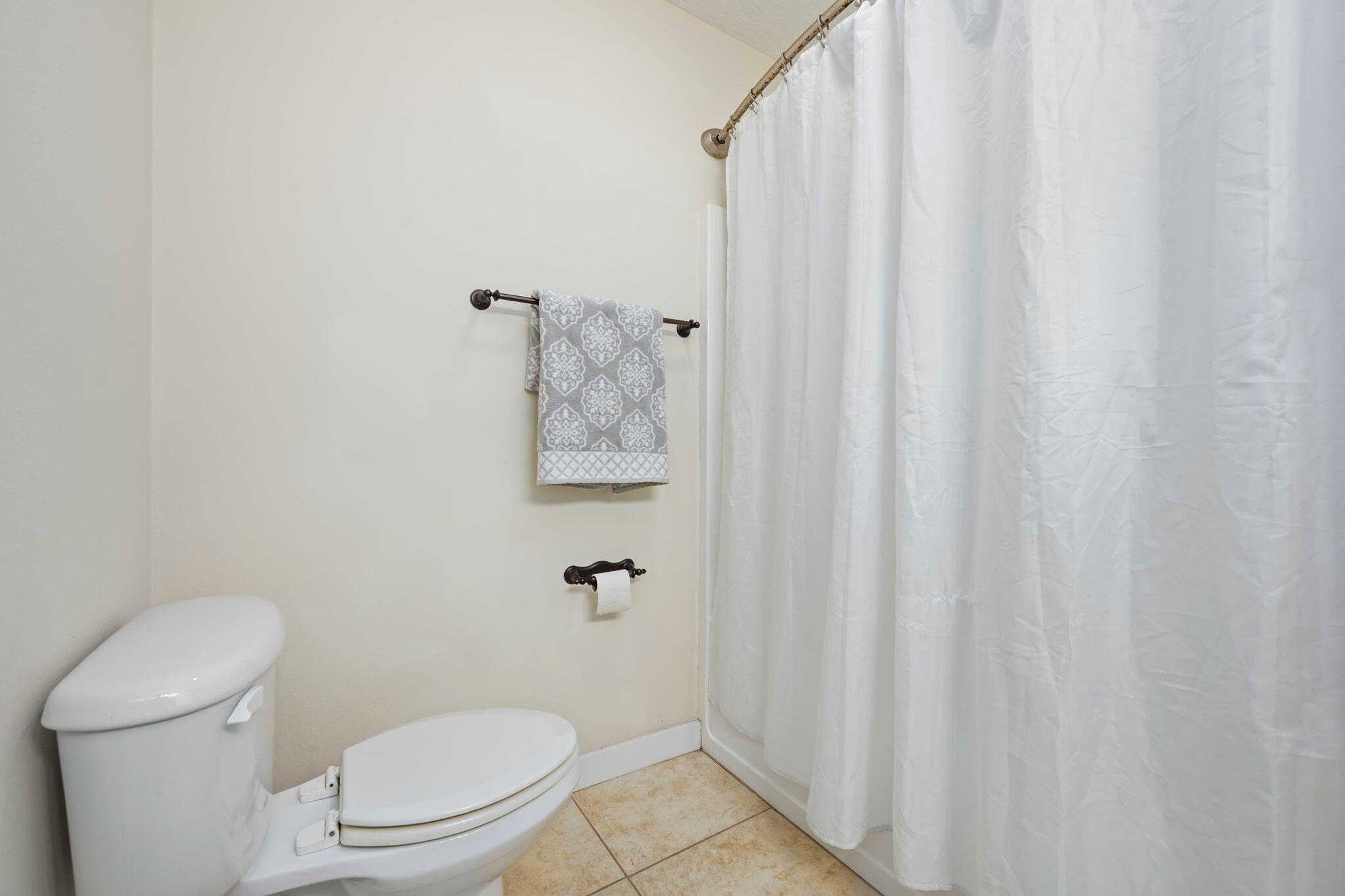 108 Hawkins Road, Unit E Fort Walton Beach, FL 32547 - Photo 21 of 41 a white toilet sitting next to a small bathroom