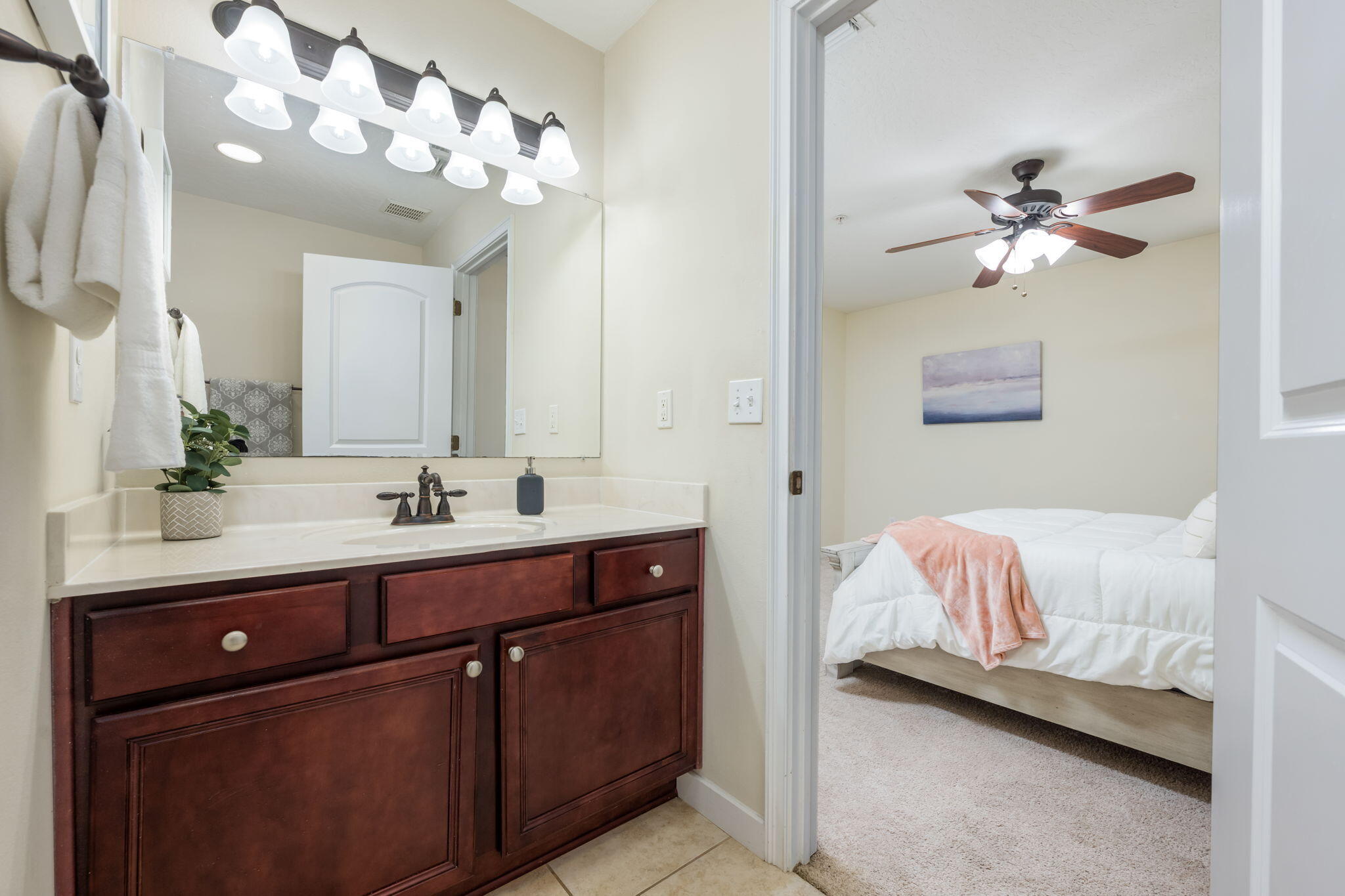108 Hawkins Road, Unit E Fort Walton Beach, FL 32547 - Photo 22 of 41 a en suite bathroom with a double vanity sink and a mirror with window