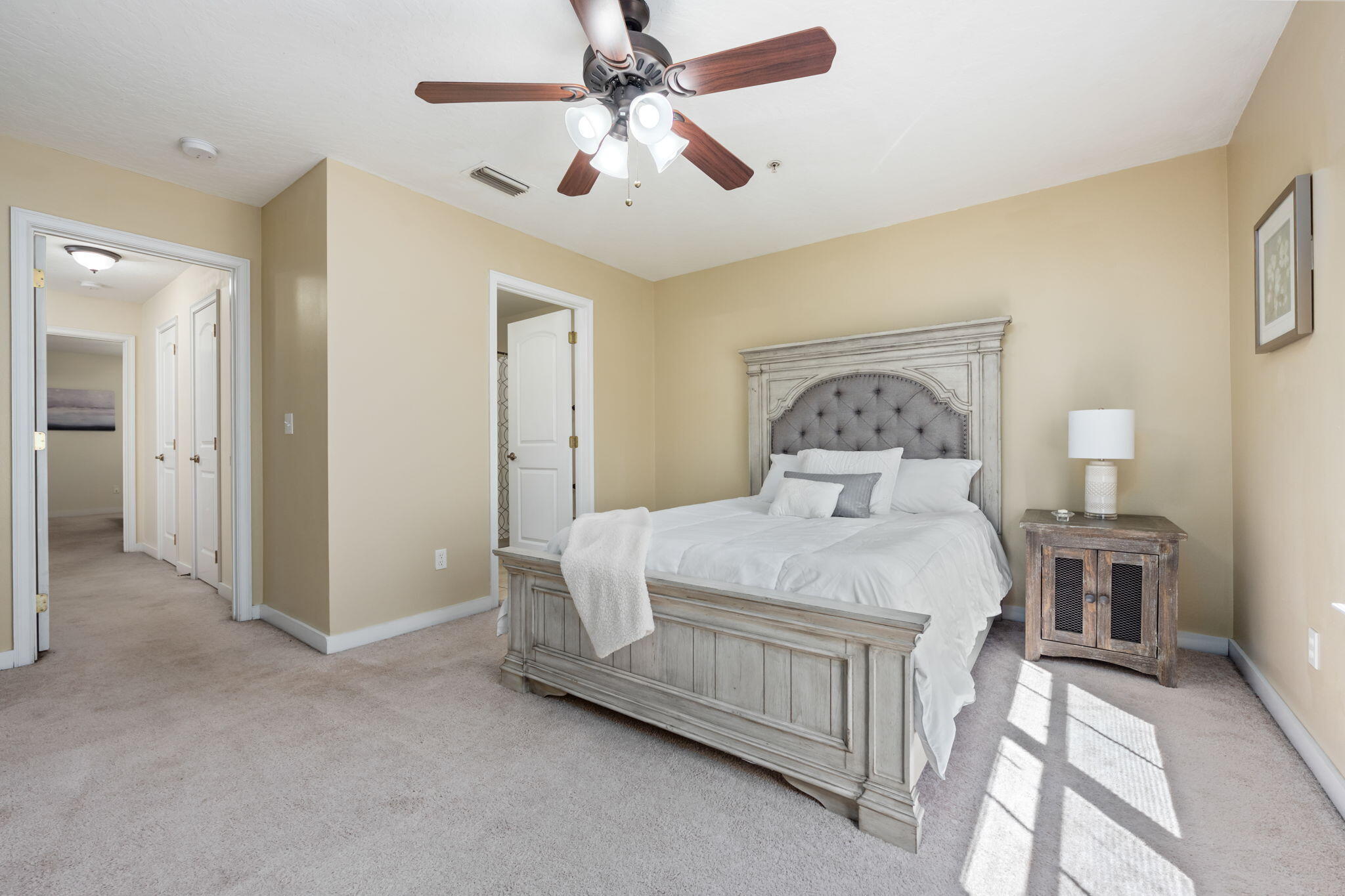 108 Hawkins Road, Unit E Fort Walton Beach, FL 32547 - Photo 25 of 41 a bedroom with a bed and a chandelier