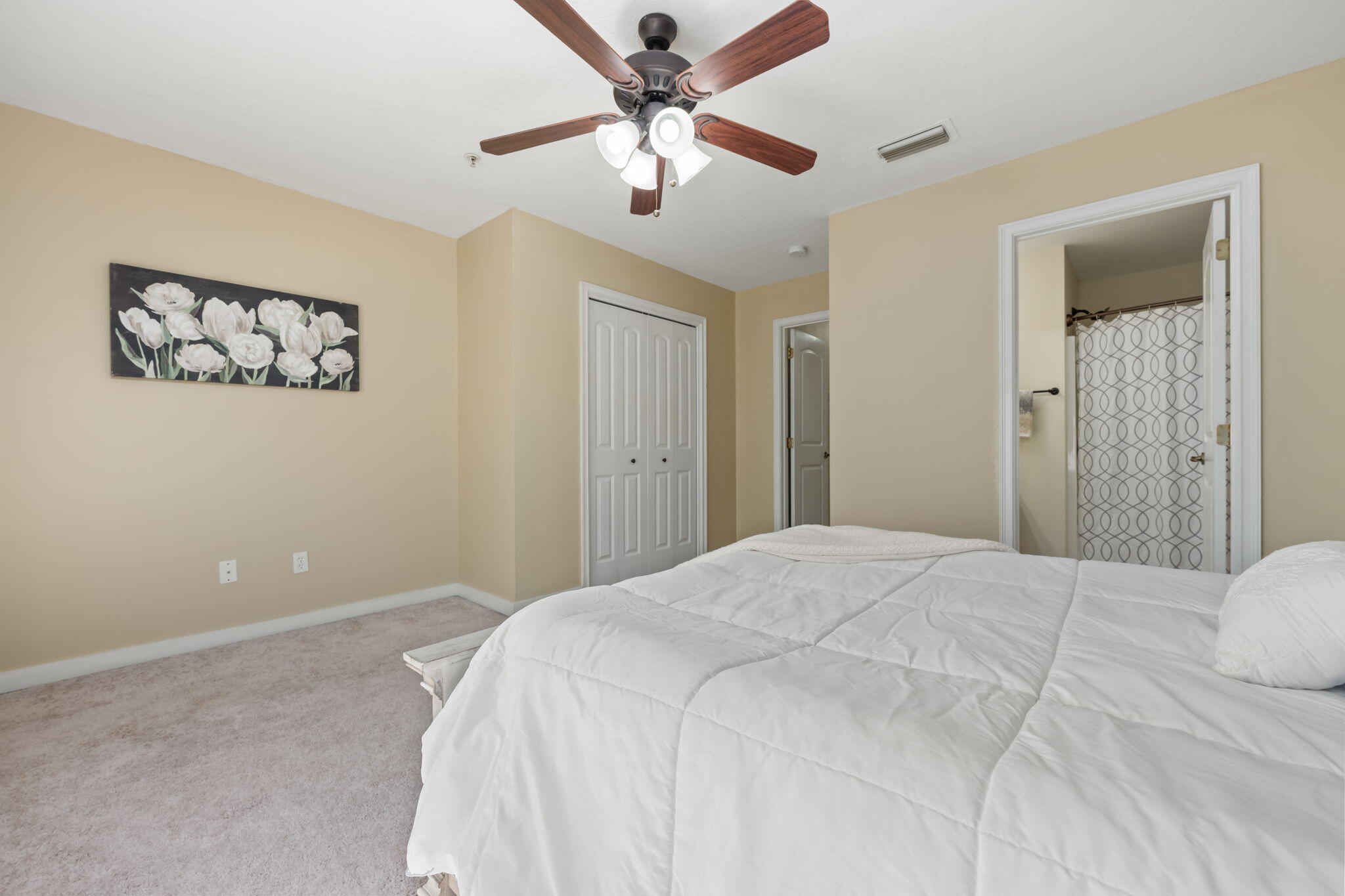 108 Hawkins Road, Unit E Fort Walton Beach, FL 32547 - Photo 26 of 41 a bedroom with a large bed and a chandelier