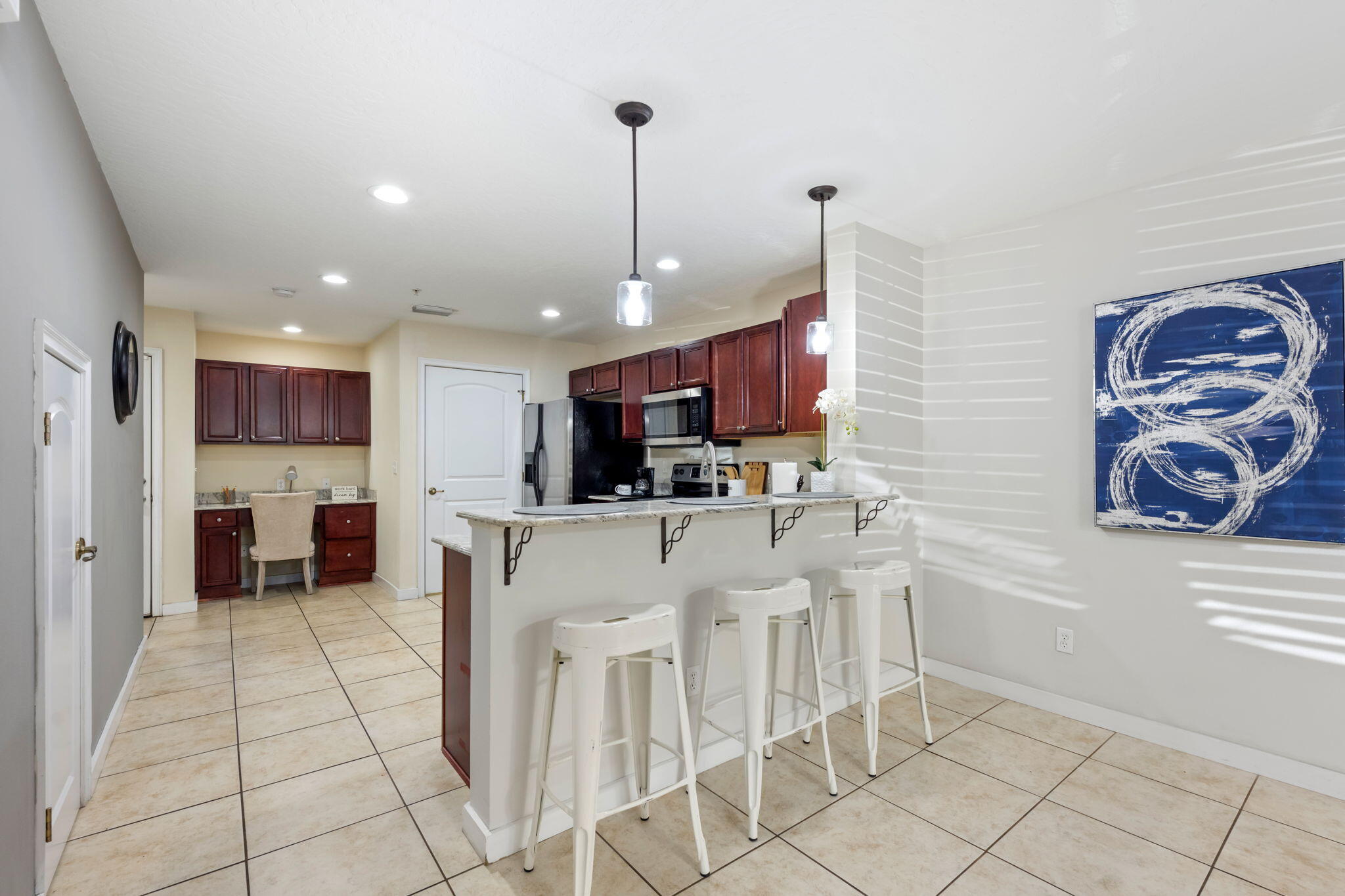 108 Hawkins Road, Unit E Fort Walton Beach, FL 32547 - Photo 9 of 41 a kitchen with stainless steel appliances kitchen island granite countertop a sink and cabinets