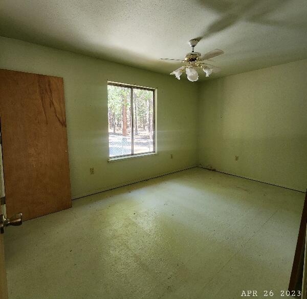 10385 Ritts Mill Road Shingletown, CA 96088 - Photo 17 of 29 an empty room with a ceiling fan and window