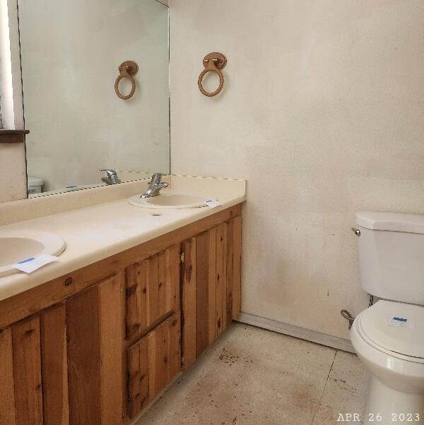 10385 Ritts Mill Road Shingletown, CA 96088 - Photo 19 of 29 a bathroom with a granite countertop sink a toilet and a mirror