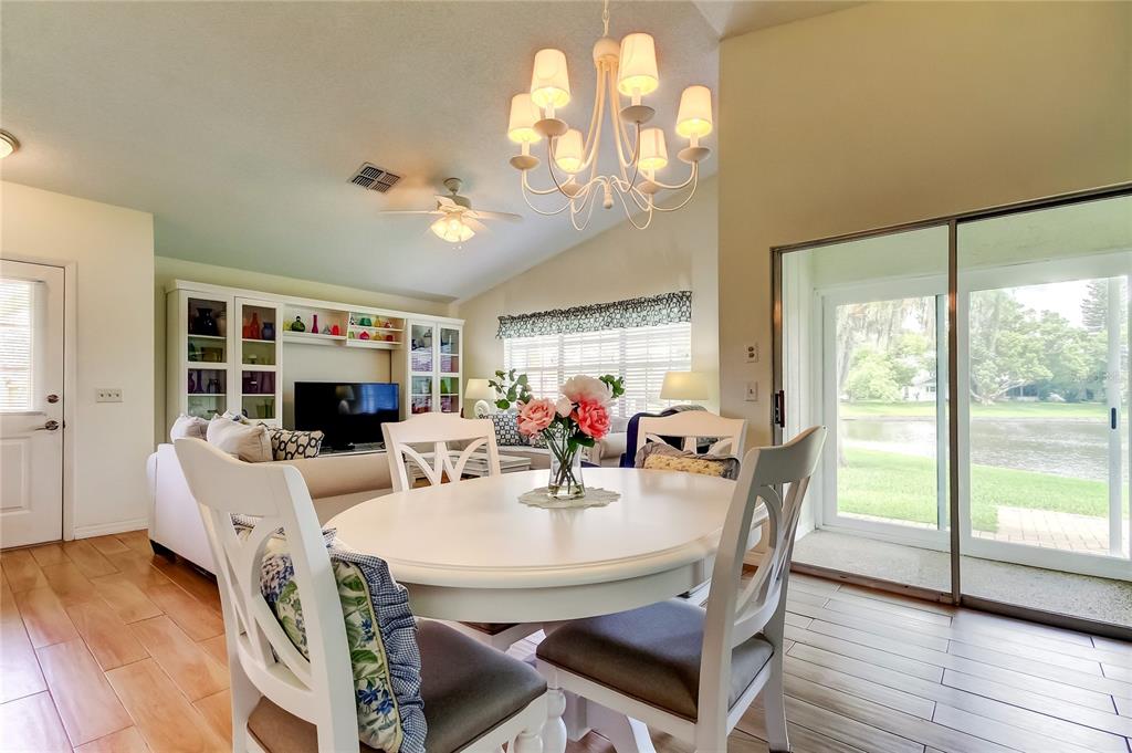 4756 Sheffield Drive New Port Richey, FL 34655 - Photo 11 of 30 a view of a dining room with furniture window and wooden floor