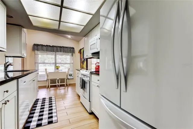 a kitchen with stainless steel appliances granite countertop a sink and cabinets