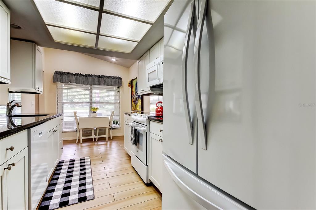 4756 Sheffield Drive New Port Richey, FL 34655 - Photo 17 of 30 a kitchen with stainless steel appliances granite countertop a sink and cabinets