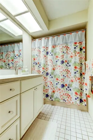 a bathroom with a sink and a shower curtain