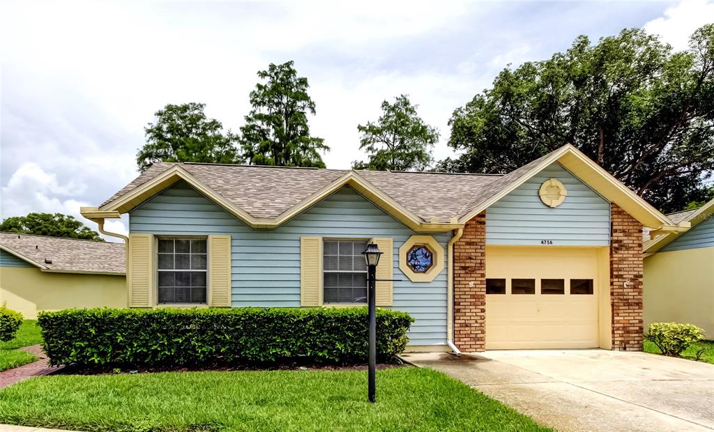 4756 Sheffield Drive New Port Richey, FL 34655 - Photo 24 of 30 a view of a house with a yard and potted plants