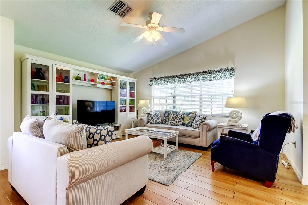 4756 Sheffield Drive New Port Richey, FL 34655 - Photo 7 of 30 a living room with furniture and a flat screen tv