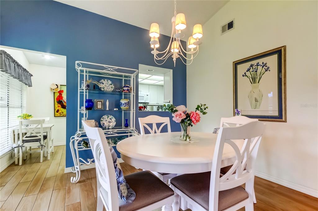 4756 Sheffield Drive New Port Richey, FL 34655 - Photo 10 of 30 a view of a dining room with furniture and wooden floor