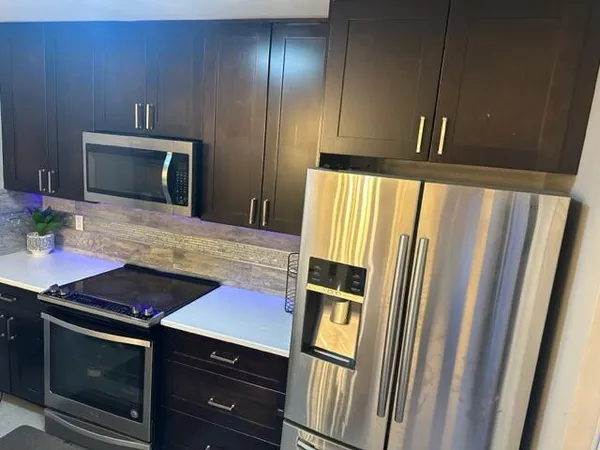a kitchen with sink and refrigerator