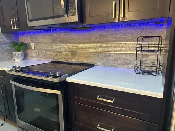 a stove top oven sitting inside of a kitchen