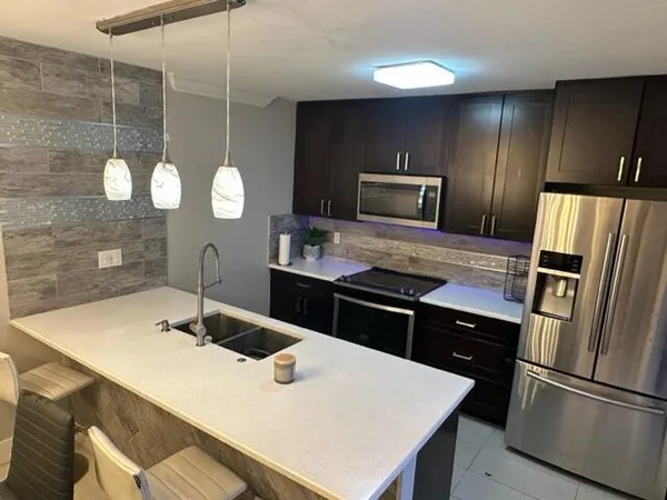a kitchen with a wooden floor and refrigerator
