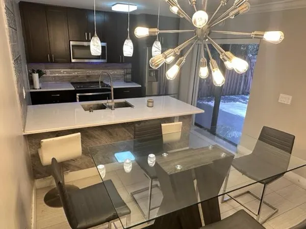 a kitchen with a table chairs and a stove