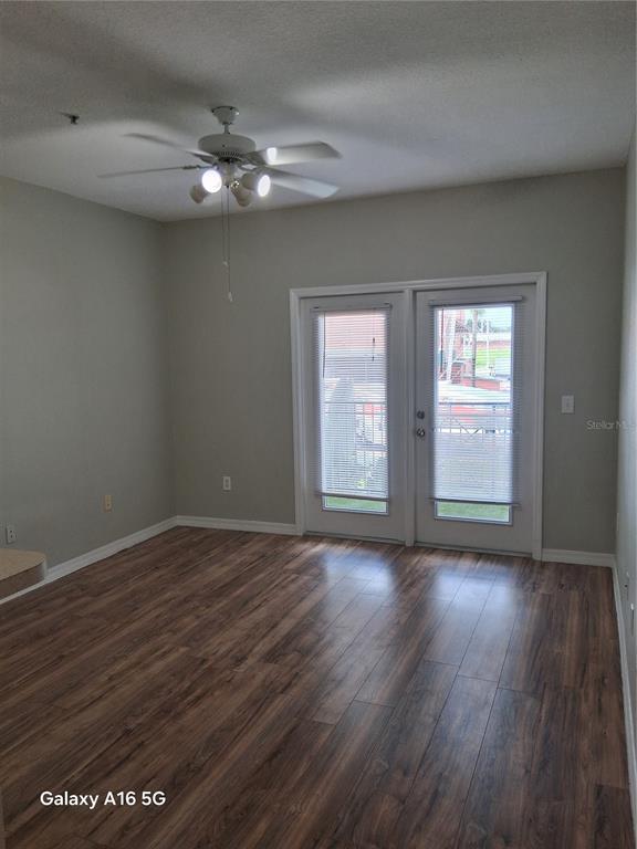1810 East Palm Avenue, Unit 5220 Tampa, FL 33605 - Photo 4 of 17 a view of an empty room with wooden floor and a window
