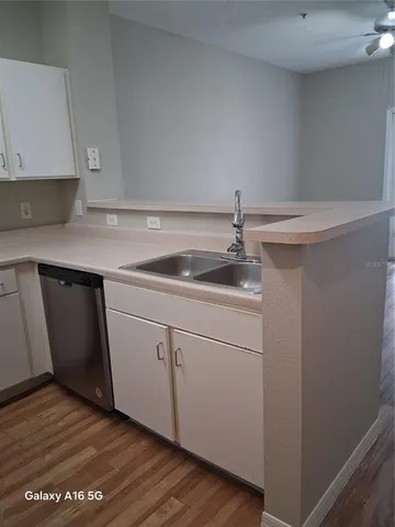 a kitchen with a sink and cabinets
