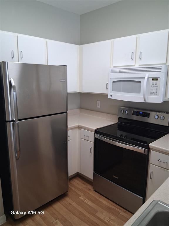 1810 East Palm Avenue, Unit 5220 Tampa, FL 33605 - Photo 6 of 17 a kitchen with a refrigerator stove and cabinets