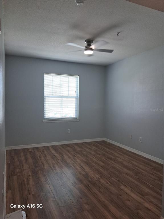 1810 East Palm Avenue, Unit 5220 Tampa, FL 33605 - Photo 8 of 17 an empty room with wooden floor and windows