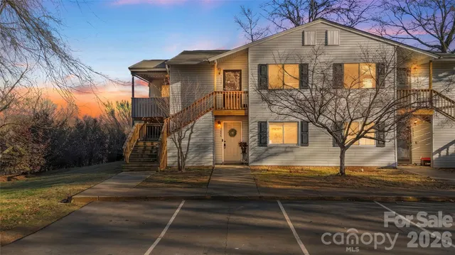 a view of a house with wooden fence