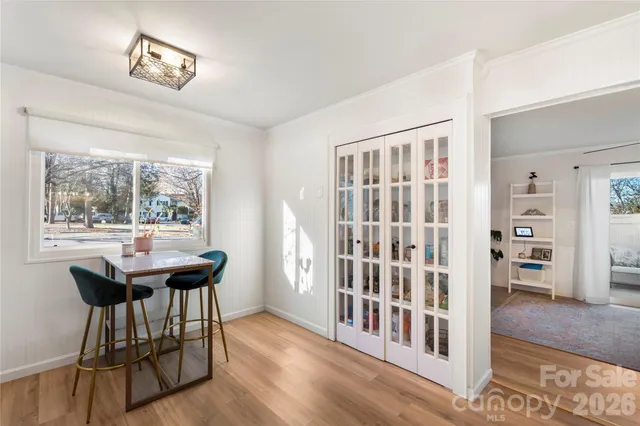 a view of a room with furniture and wooden floor