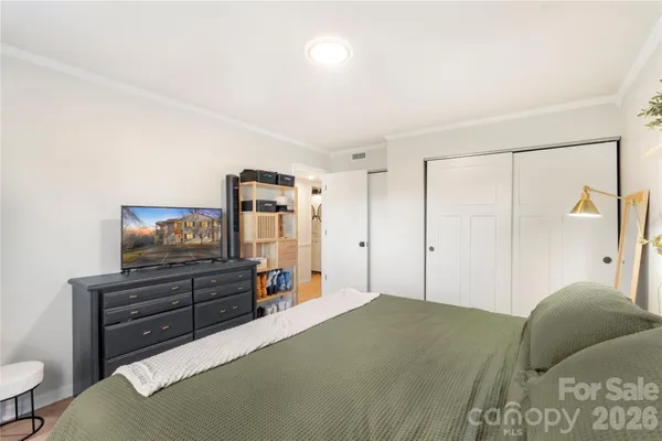 a bedroom with a bed and a television
