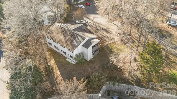 a backyard of a house with large trees