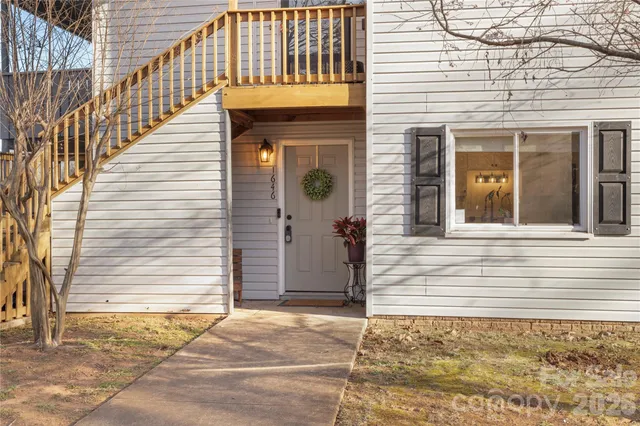 a view of a house with wooden fence