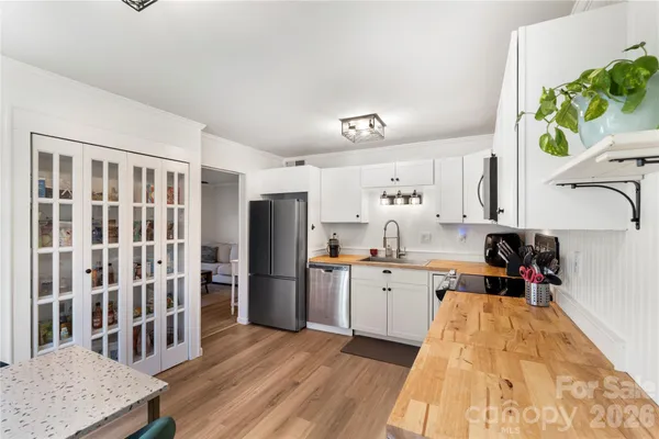 a kitchen with stainless steel appliances granite countertop a refrigerator and a sink