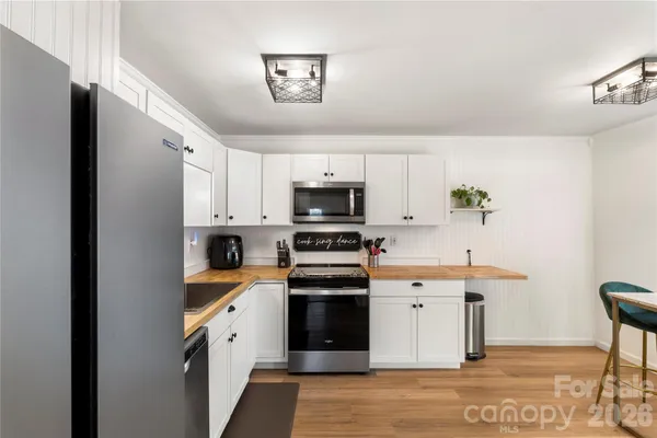 a kitchen with stainless steel appliances granite countertop a stove and a refrigerator