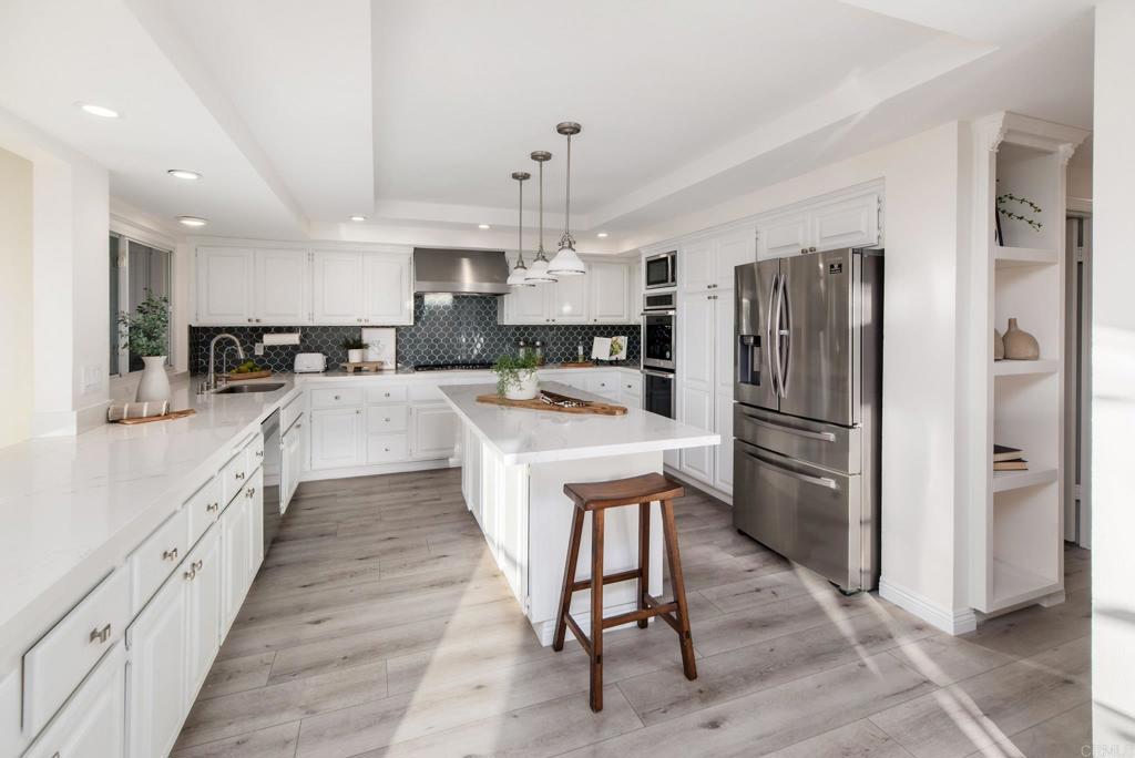 2515 Luciernaga Street Carlsbad, CA 92009 - Photo 12 of 58 a kitchen with refrigerator a sink and cabinets