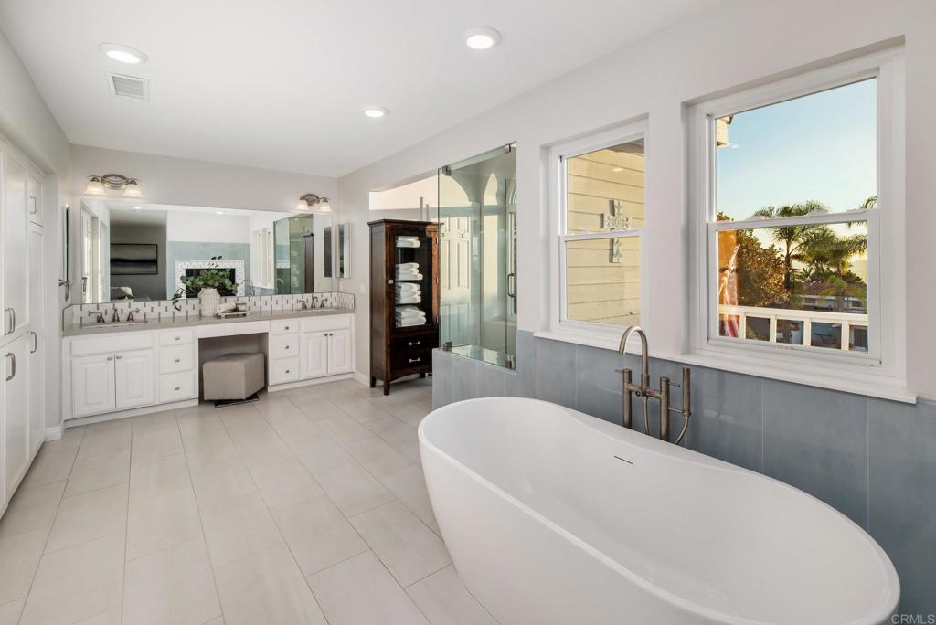2515 Luciernaga Street Carlsbad, CA 92009 - Photo 27 of 58 a bathroom with a tub a sink and a large mirror