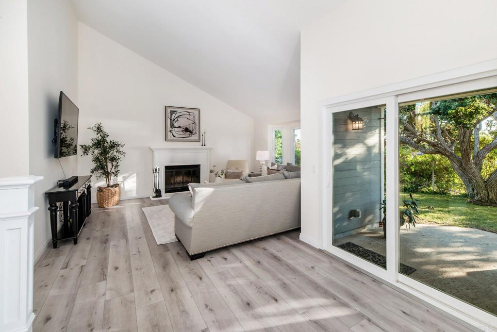 2515 Luciernaga Street Carlsbad, CA 92009 - Photo 6 of 58 a living room with furniture a flat screen tv and a fireplace