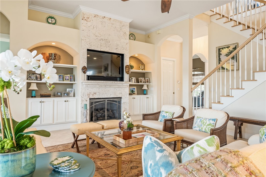 1286 Riverside Place Vero Beach, FL 32963 - Photo 11 of 36 a living room with furniture a fireplace and a flat screen tv