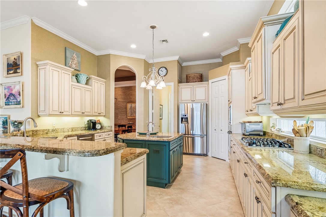 1286 Riverside Place Vero Beach, FL 32963 - Photo 13 of 36 a kitchen with a sink stove and cabinets