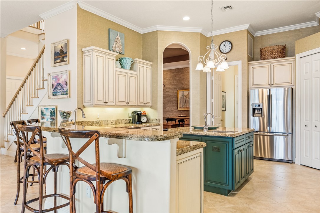 1286 Riverside Place Vero Beach, FL 32963 - Photo 15 of 36 a kitchen with stainless steel appliances granite countertop a sink and cabinets