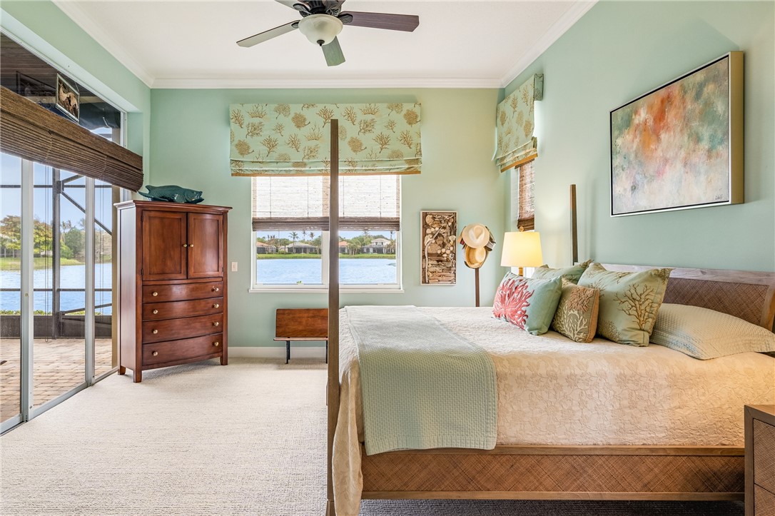 1286 Riverside Place Vero Beach, FL 32963 - Photo 19 of 36 a bedroom with a large bed and a large window