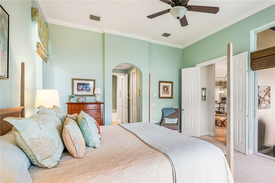 1286 Riverside Place Vero Beach, FL 32963 - Photo 20 of 36 a bedroom with a bed and a chandelier