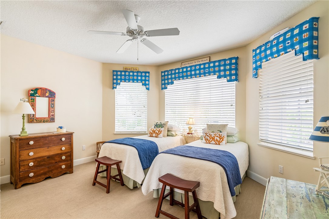 1286 Riverside Place Vero Beach, FL 32963 - Photo 24 of 36 a bedroom with two beds and a dresser