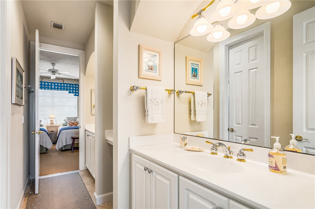 1286 Riverside Place Vero Beach, FL 32963 - Photo 25 of 36 a en suite bathroom with a sink and a mirror