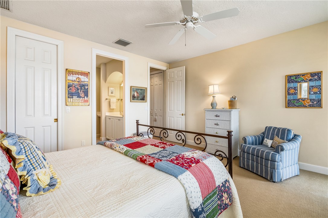 1286 Riverside Place Vero Beach, FL 32963 - Photo 27 of 36 a bedroom with a bed and a couch