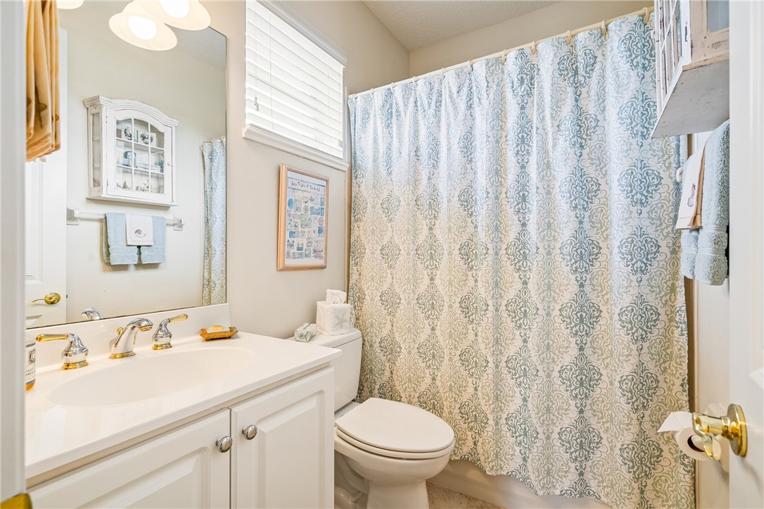 1286 Riverside Place Vero Beach, FL 32963 - Photo 31 of 36 a bathroom with a sink a toilet and a mirror